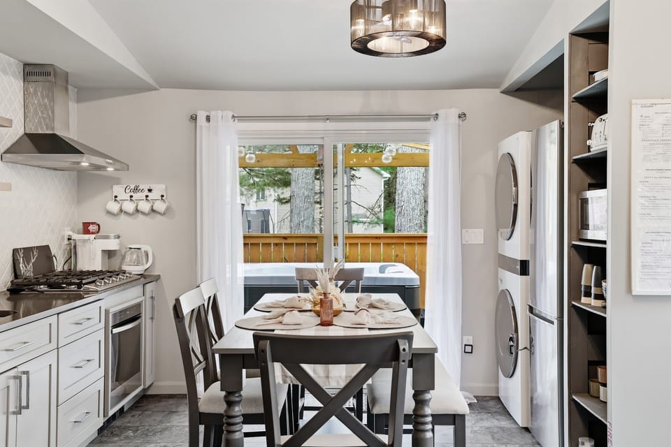 Share meals, stories, and memories around the kitchen table, connecting both the living room and the deck. 