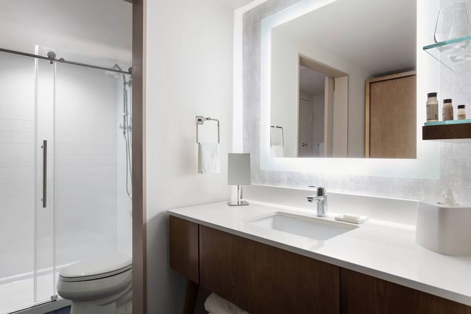 Refresh in a sleek bathroom with a bright, spa-like glow.