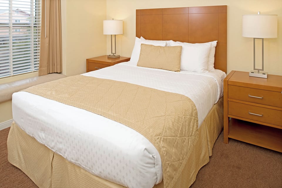 Unwind into crisp linens and warm bedside lighting nightly.