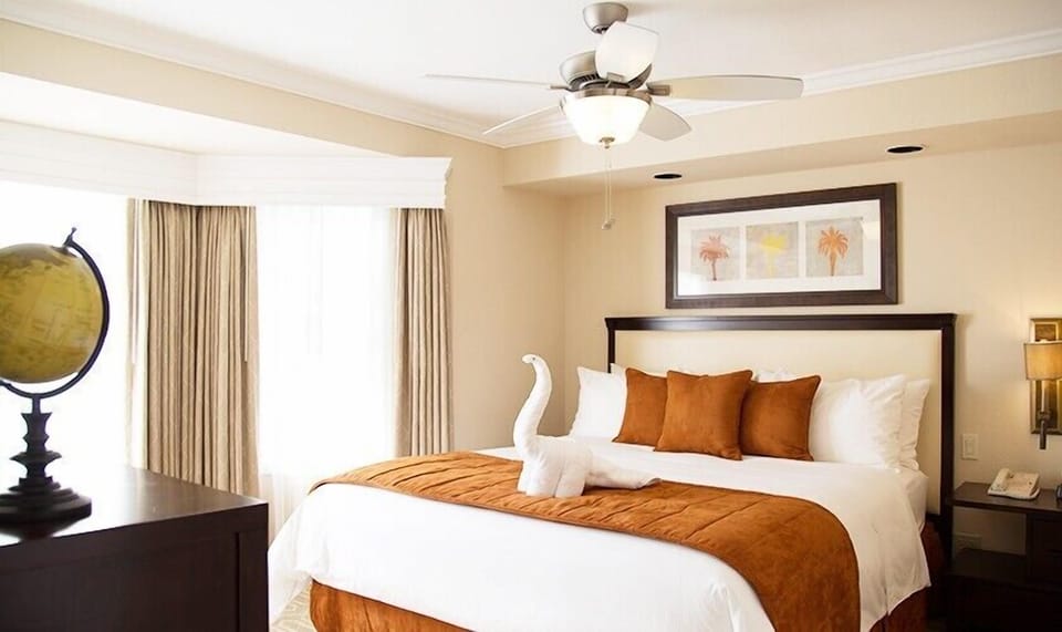 Unwind in a sunlit bedroom with crisp linens and plush pillows.
