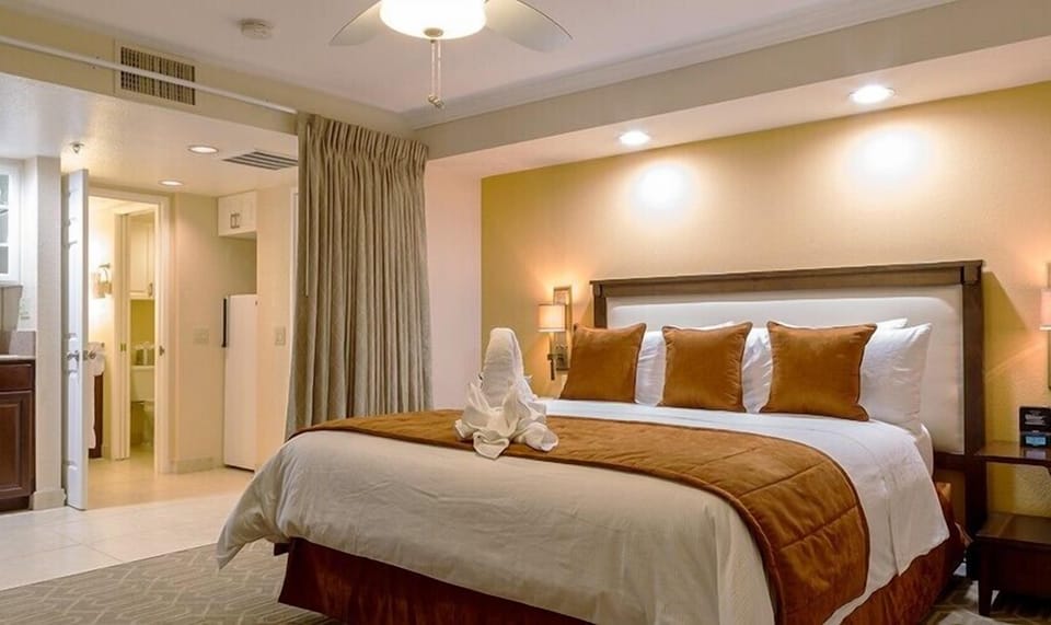Drift off in a spacious bed under warm, calming lights.