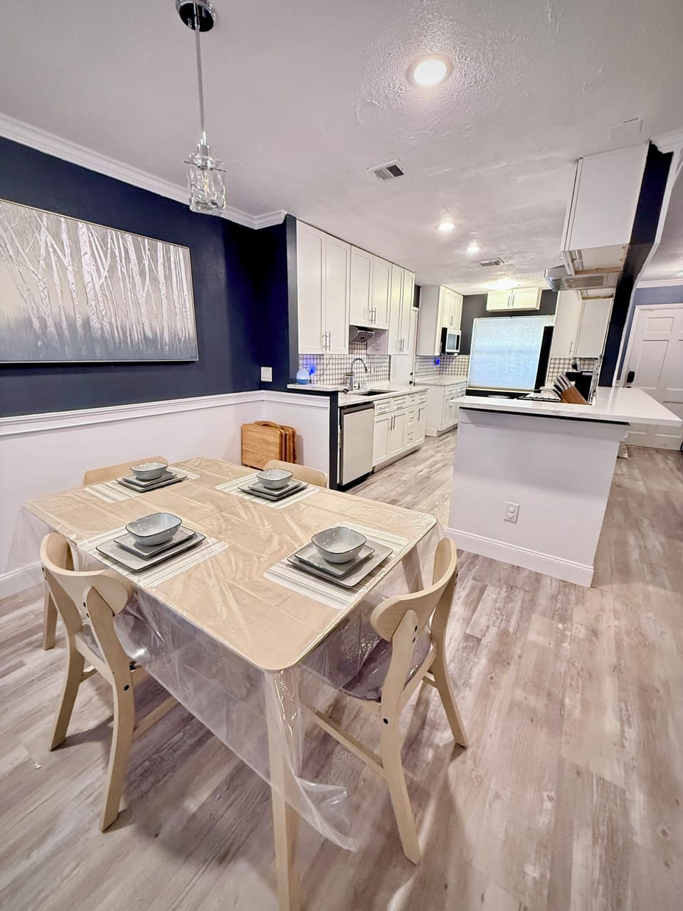 Bright modern kitchen and dining space with seating for four