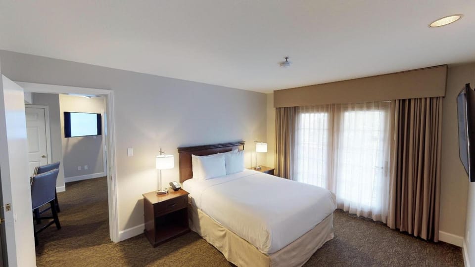 Sink into crisp linens and enjoy a bright, restful bedroom.