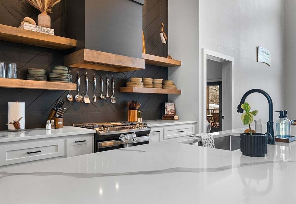 The bright and airy kitchen features high-end appliances, generous counter space, and an open design that keeps everyone connected.