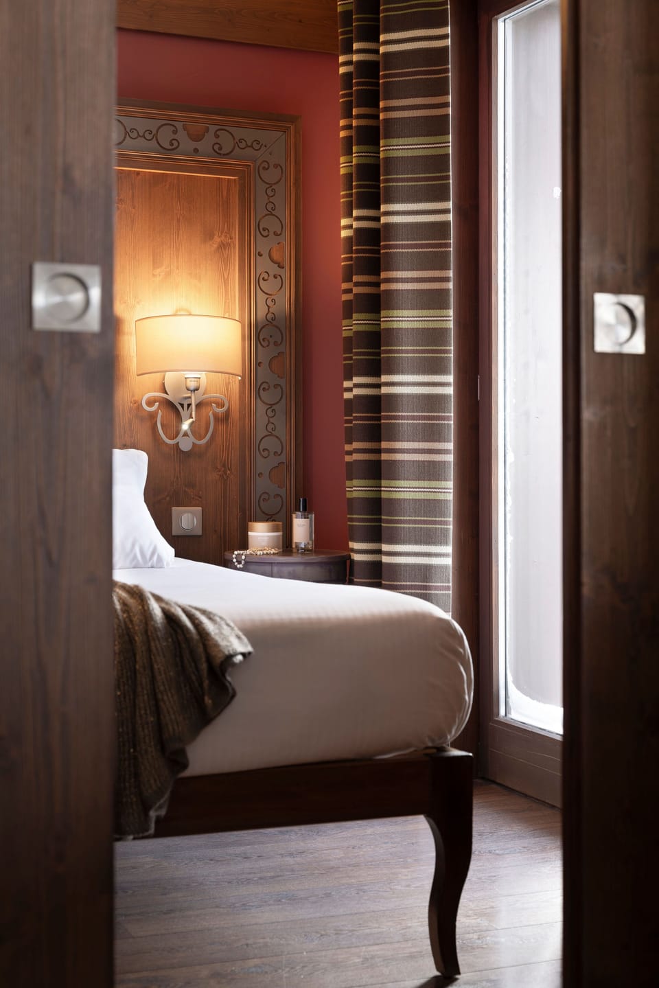 The second bedroom with two single beds and warm wood panelling — room for the whole family after a day exploring the Belleville Valley trails.