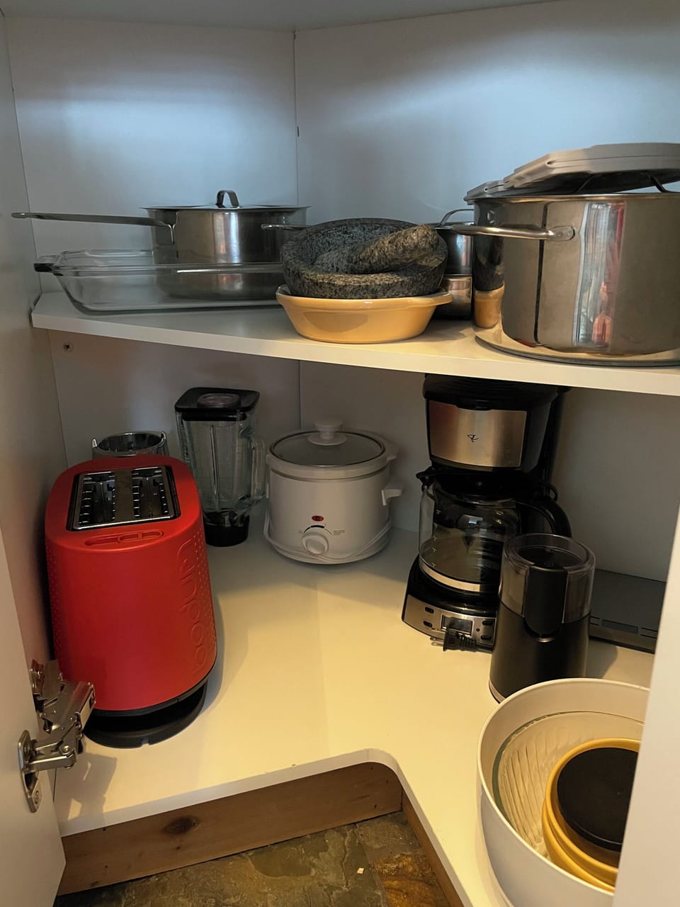 Toaster, blender, slow cooker, drip coffee machine, pots & pans.