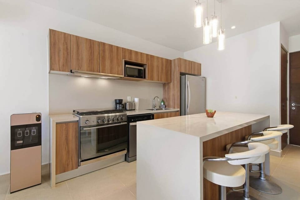 Fully stocked kitchen with filtered drinking water, coffee machine, toaster, blender, dishwasher, microwave, refrigerator, oven, and a 6-burner stove, plus everything you need to make a meal. The kitchen island is perfect for gathering together.