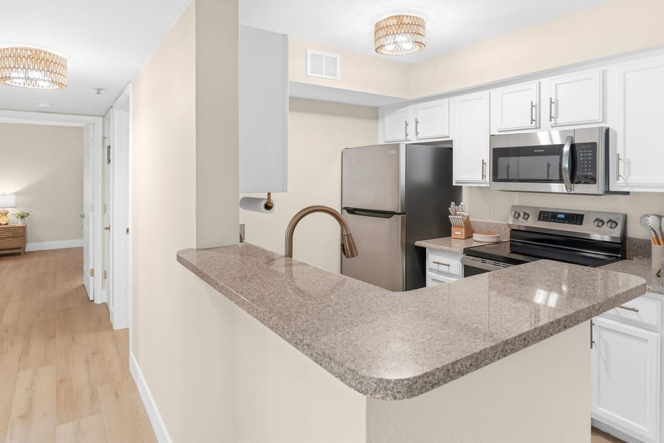 Kitchen and granite counter top bar adjacent bathroom/bedroom hallway