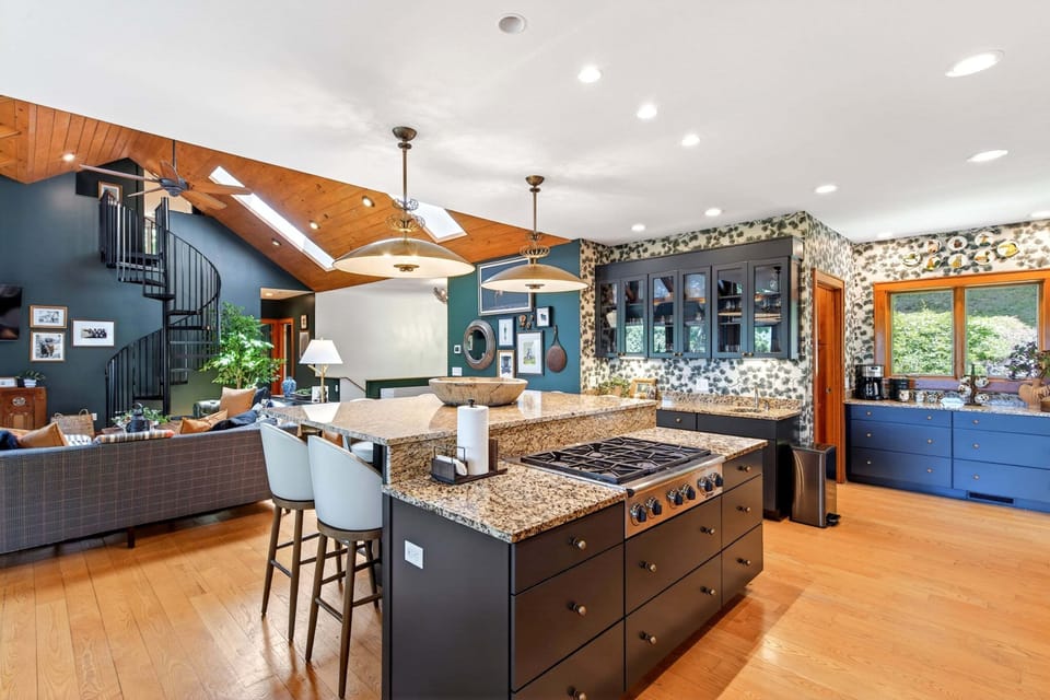 Well-equipped kitchen with gas range, dishwasher, and luxe, oversized island with seating for 6