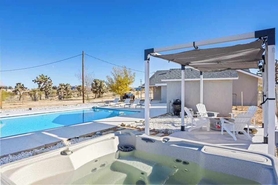 Backyard features hot tub, firepit, BBQ