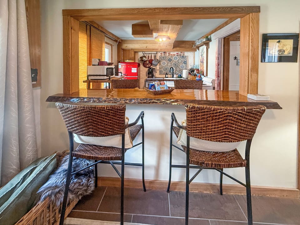 Cozy breakfast bar with rustic charm and warm wood-beam kitchen views