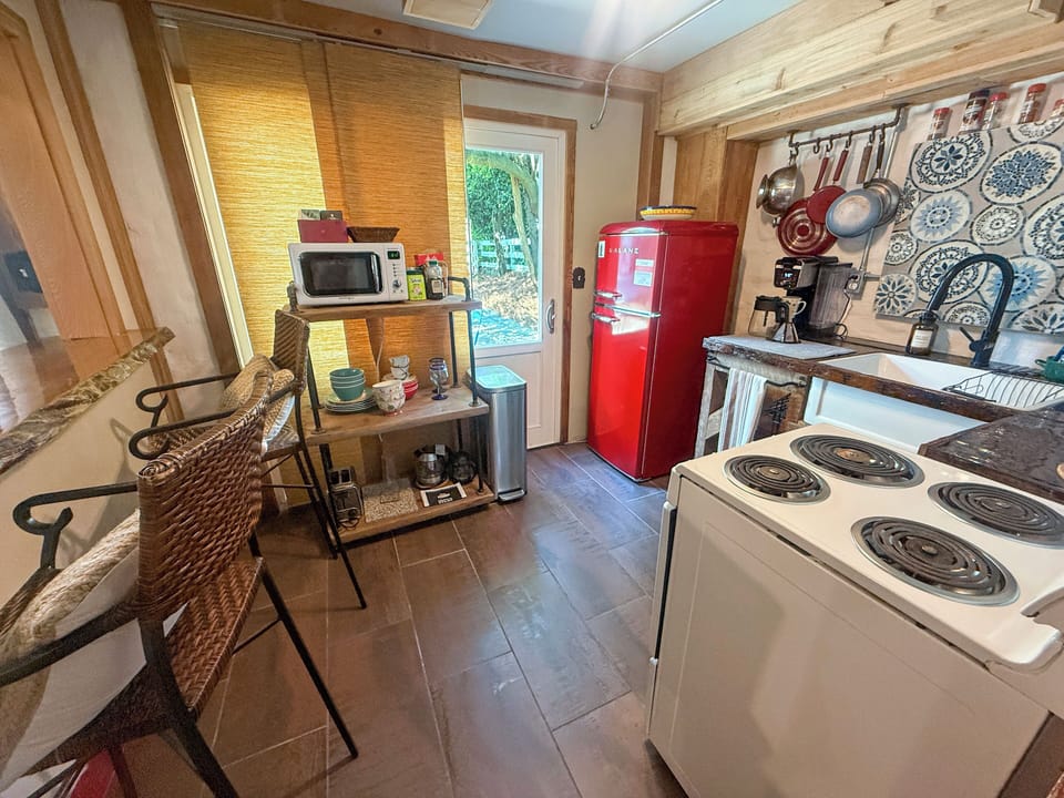 Charming rustic kitchen with vintage red fridge and cozy breakfast bar
