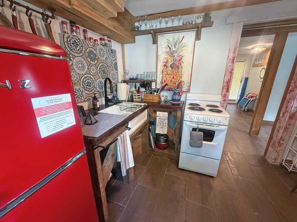 Charming rustic kitchenette with retro red fridge and southwestern style
