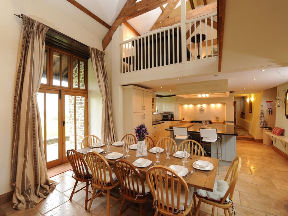Bright dining area with French doors leading to garden | Mole Hall, Torrington