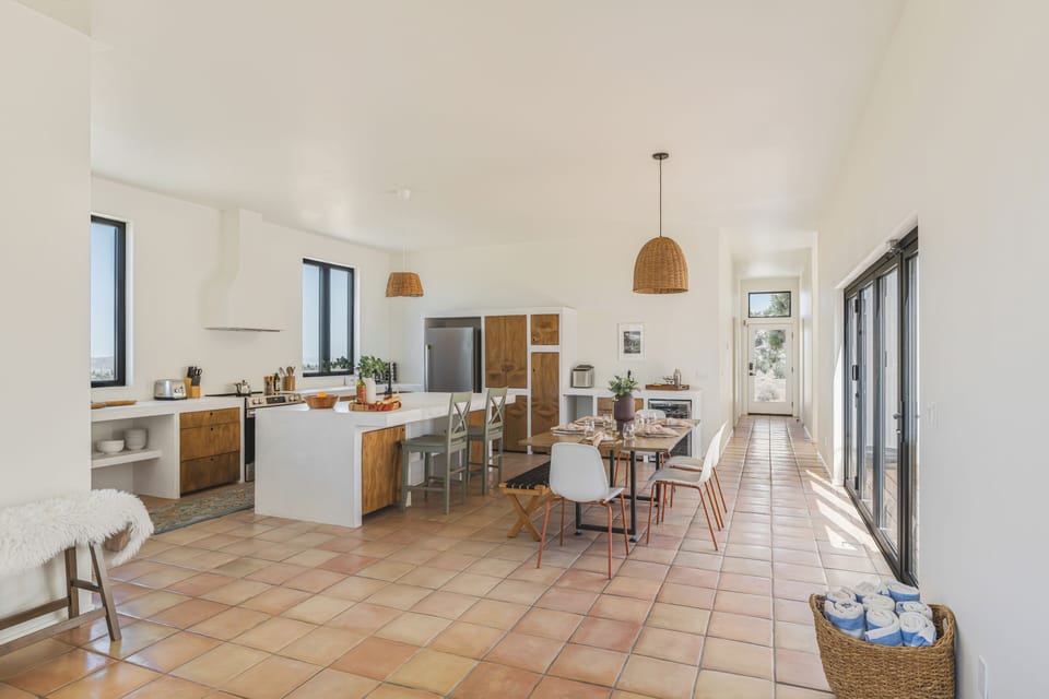 A grand view showing the effortless transition between cooking, dining, and relaxing.