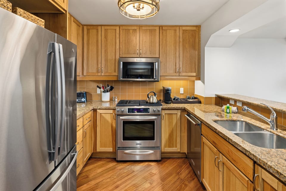 The open kitchen and dining space offer the perfect setting for home-cooked meals, morning coffee, and gathering with family or friends.