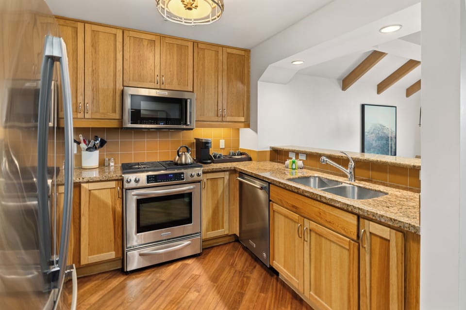 Prepare meals with ease in the fully equipped kitchen featuring modern appliances, ample counter space, cookware, dishware, and all the essentials for your stay.