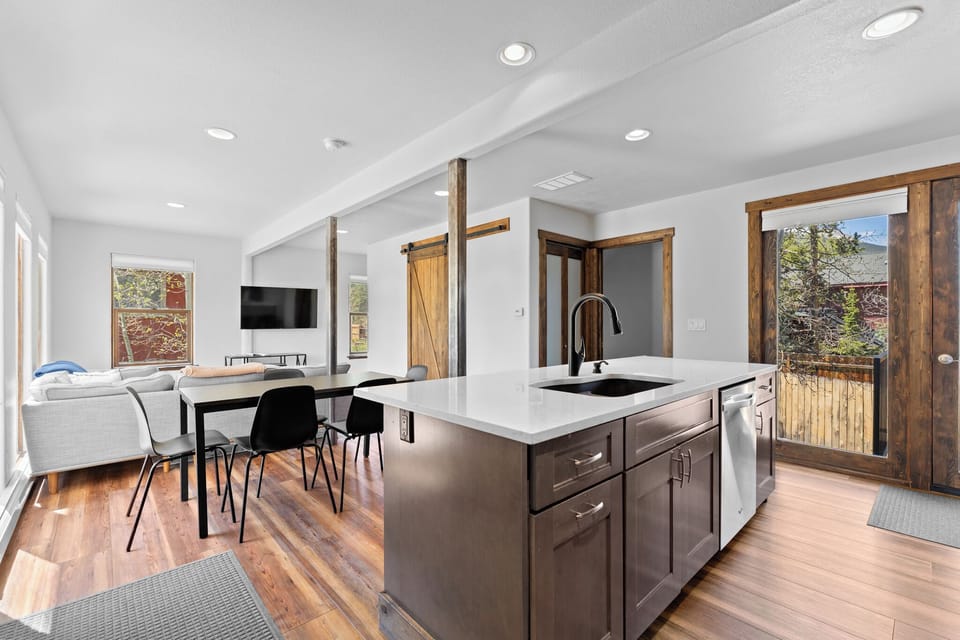 A bright, open-concept space where your vacation unfolds—cook, dine, and unwind all in one inviting area with mountain views just beyond the door.