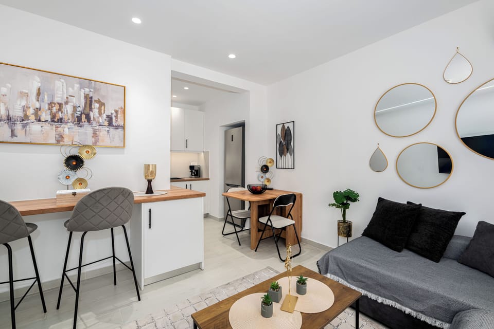 Chic open-plan living with modern decor and cosy seating area.
