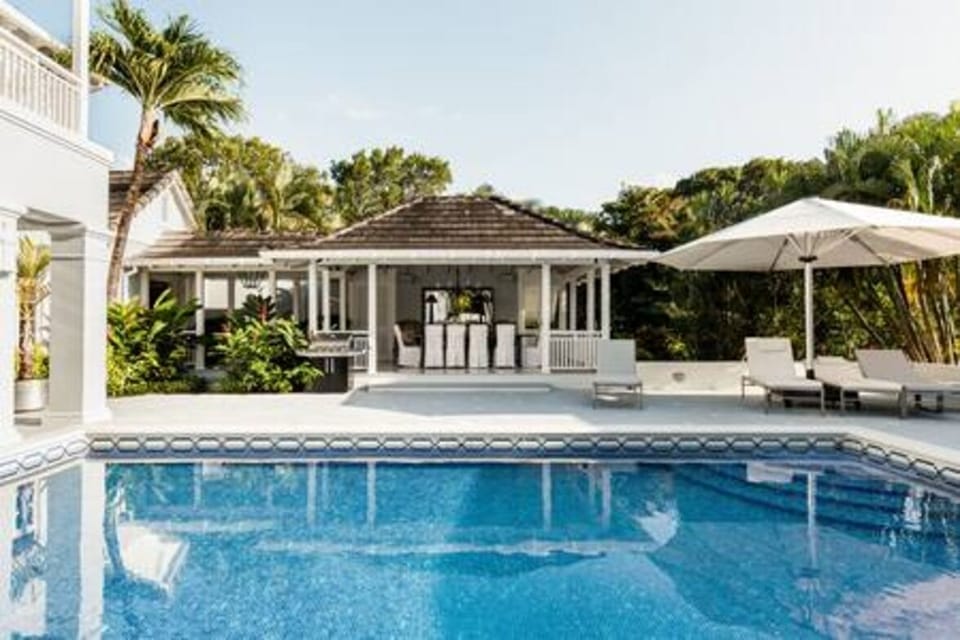 Stunning private pool area with wet bar, sun loungers and sun umbrellas.