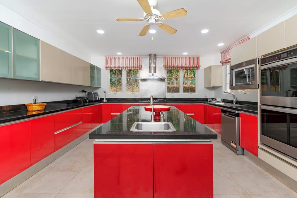 Main Living House's Kitchen which includes a double oven, microwave, American style fridge, hob, toaster and kettle.