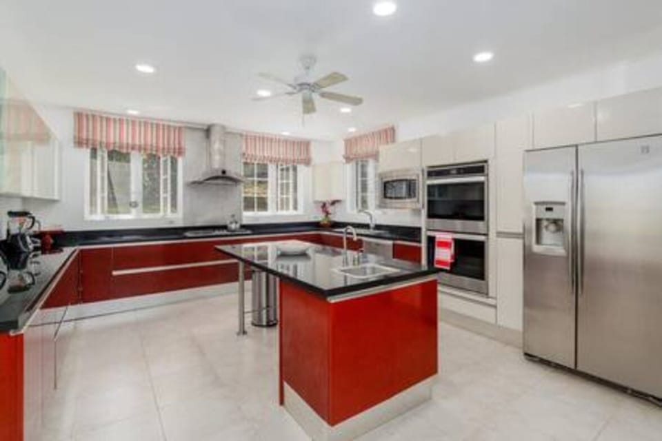 Main Living House's Kitchen which includes a double oven, microwave, American style fridge, hob, toaster and kettle.