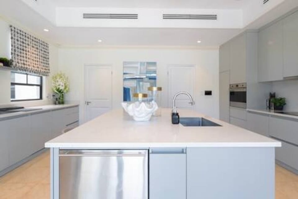 Beautifully appointed kitchen with a full range of appliances, air conditioning, ceiling fan and access out to the pool area.