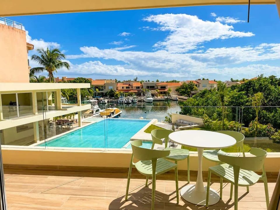 Private terrace with direct views of the pool and marina canal.