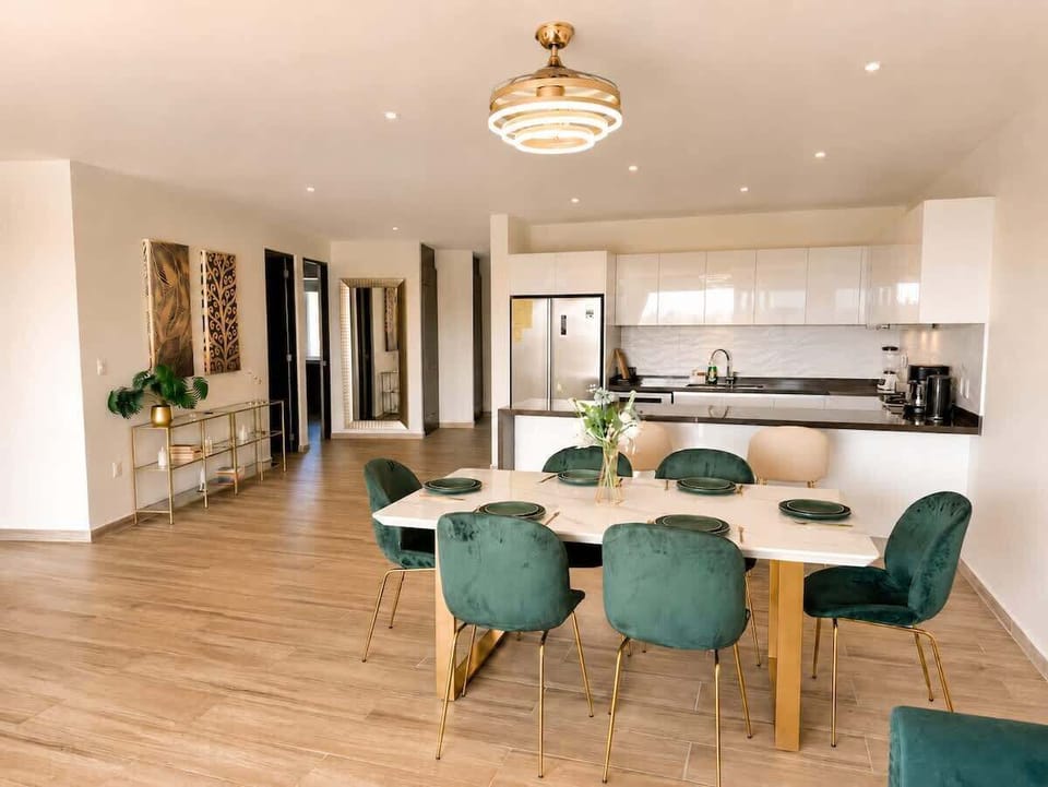 Stylish dining area and equipped kitchen for comfortable meals at home.