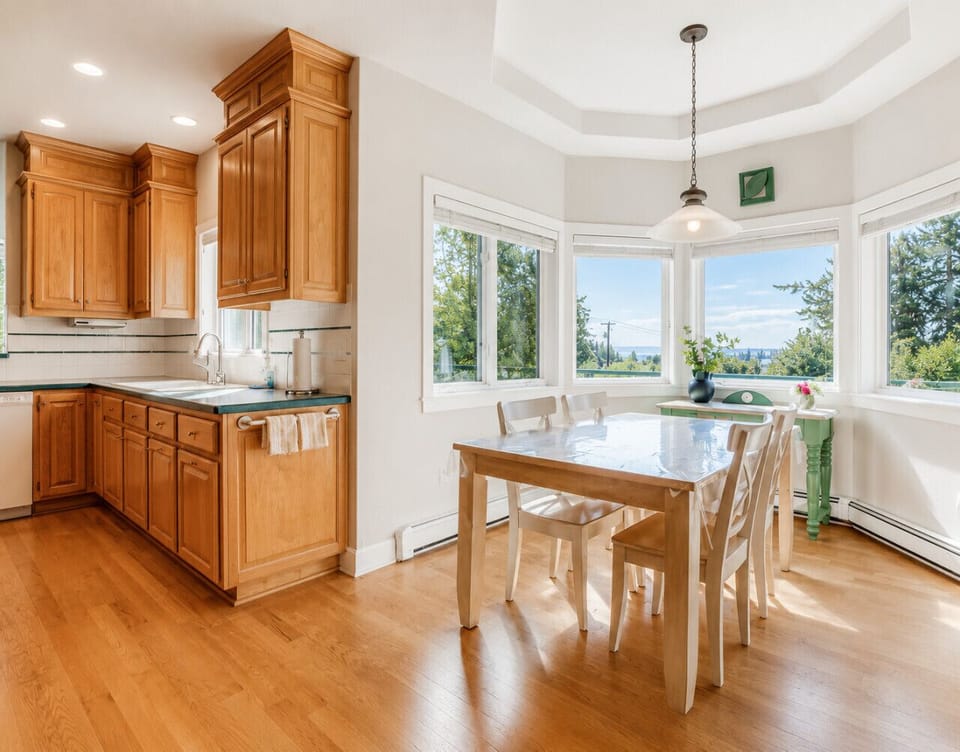 Bright eat-in kitchen with scenic windows and comfortable casual dining space