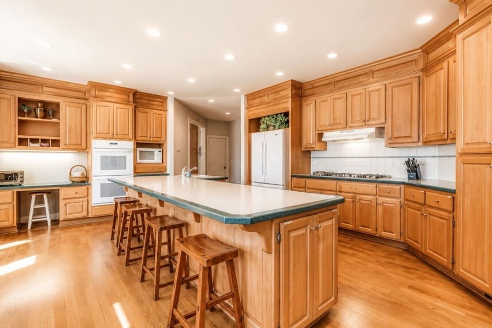 Chef`s kitchen with oversized island and bar seating for the group