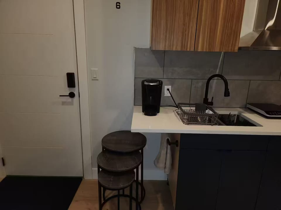 Kitchen with full sink and coffee maker