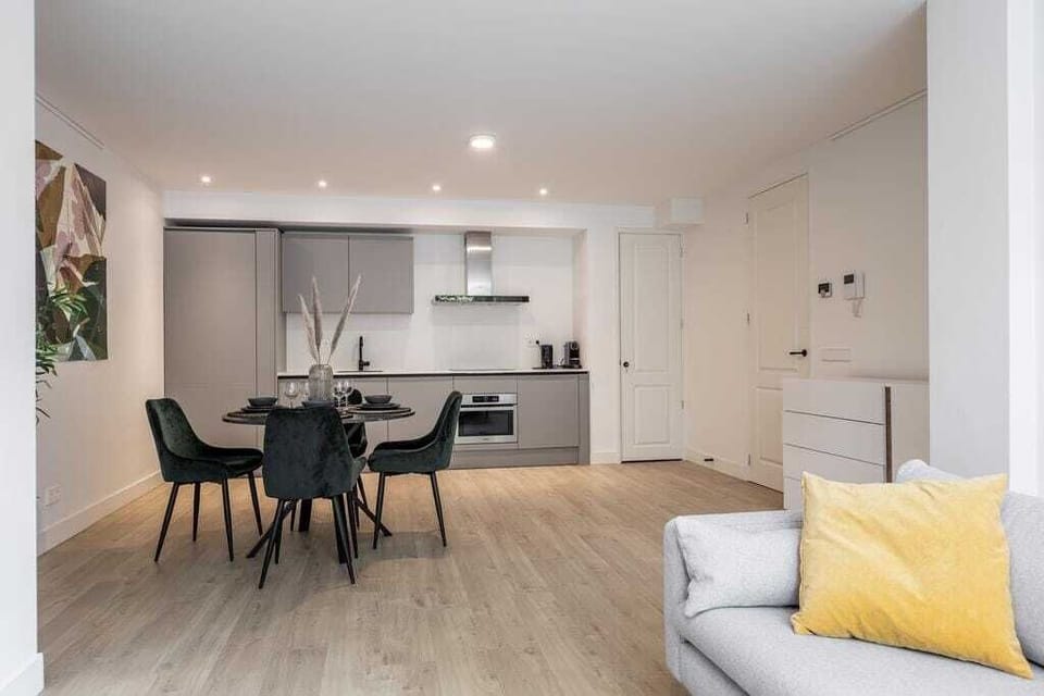 The linear layout keeps the space efficient and uncluttered, making it easy to cook while remaining connected to the dining and living areas.