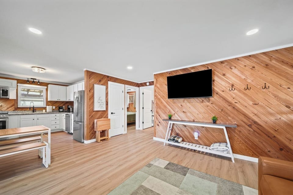Open living room includes a leather sleeper sofa and leather swivel chairs to view the 55" SmartTV.  