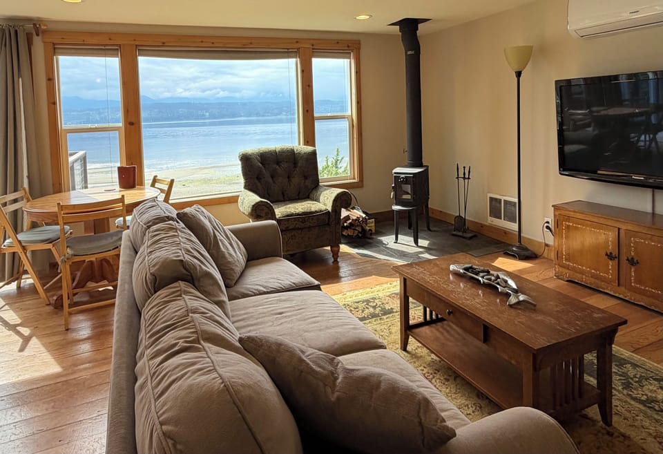Large sofa bed, dining area, and large flat-screen TV.