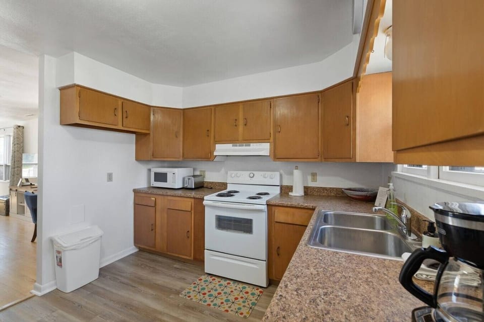 Fully functional kitchen with warm cabinetry, modern appliances, and homestyle touches for a comfortable stay!