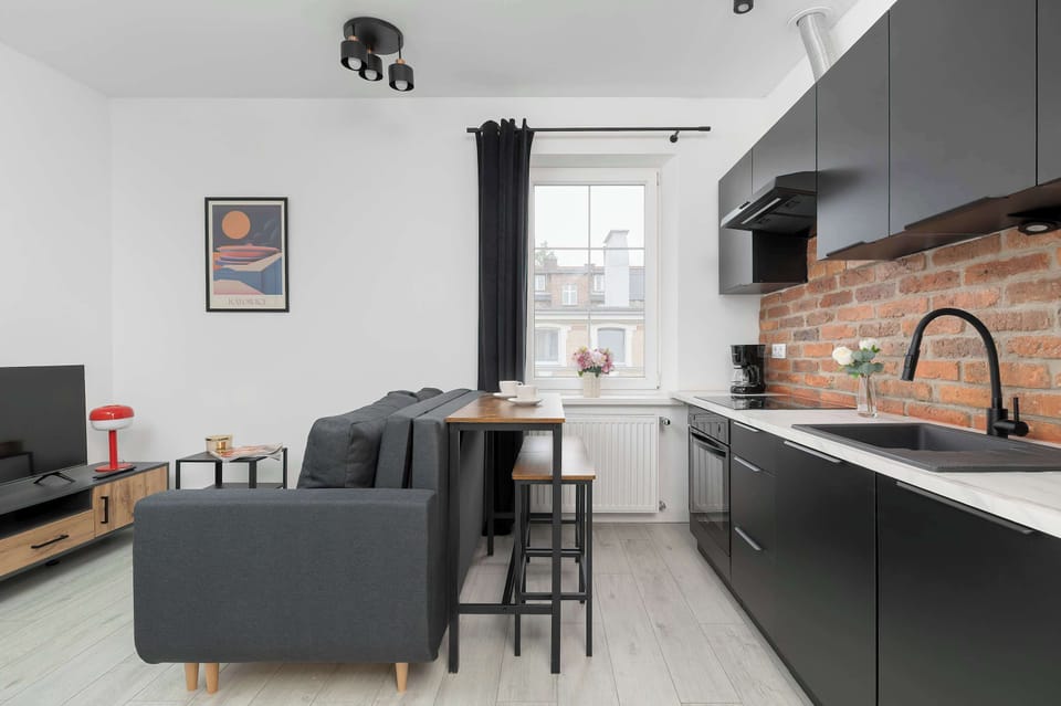 Stylish living room connected to a modern kitchen with industrial accents.