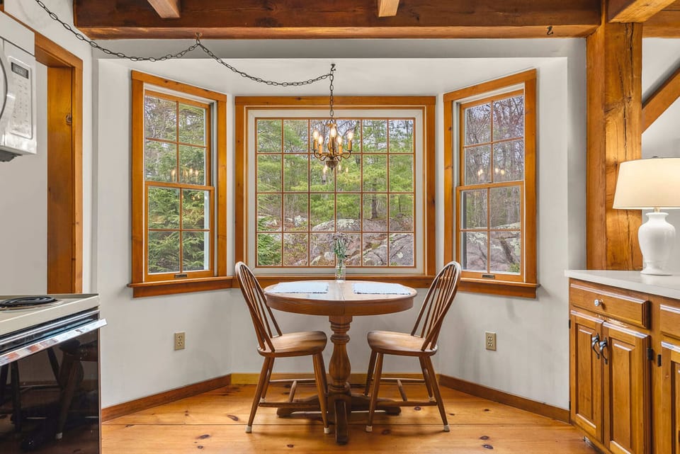Picture perfect breakfast nook with beautiful views out to the forest.