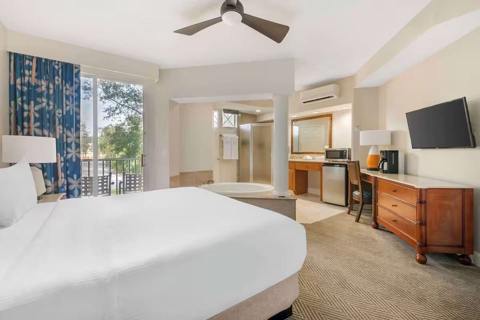 Relax in a roomy suite with balcony, TV, and mini-fridge.