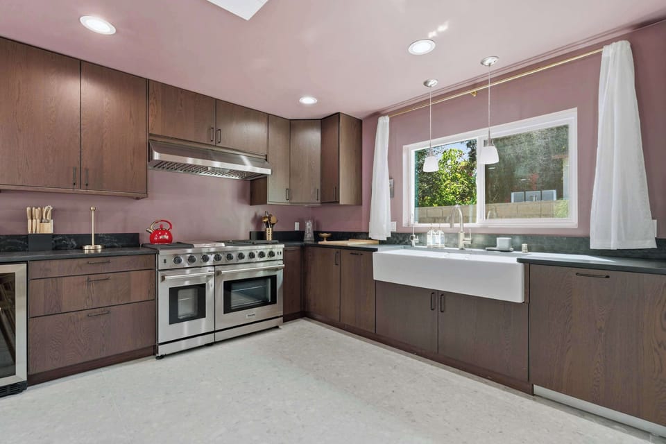 Kitchen — Thor 6-Burner Dual Oven Range, Dark Wood Cabinets, Black Granite Counters & Farmhouse Sink