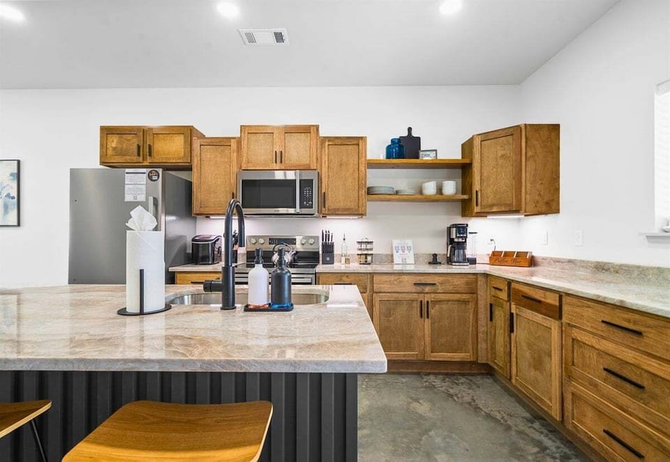 Clean, open layout with plenty of counter space and warm wood accents.