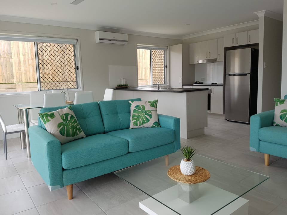 Bright modern living with stylish seating, dining area, and full kitchen