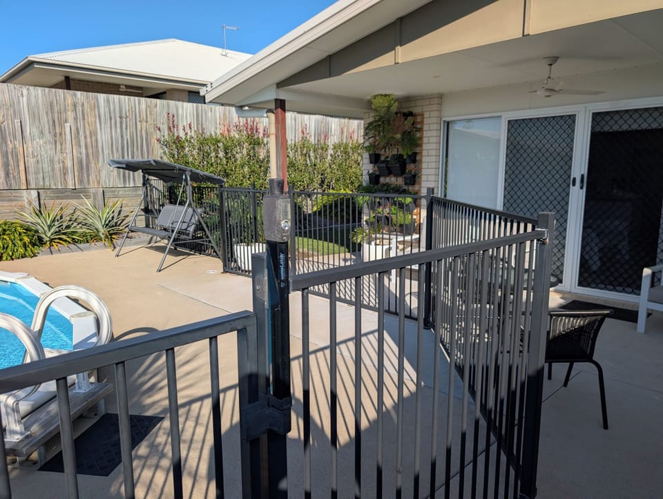 Private fenced pool patio with shaded seating and relaxing outdoor vibe
