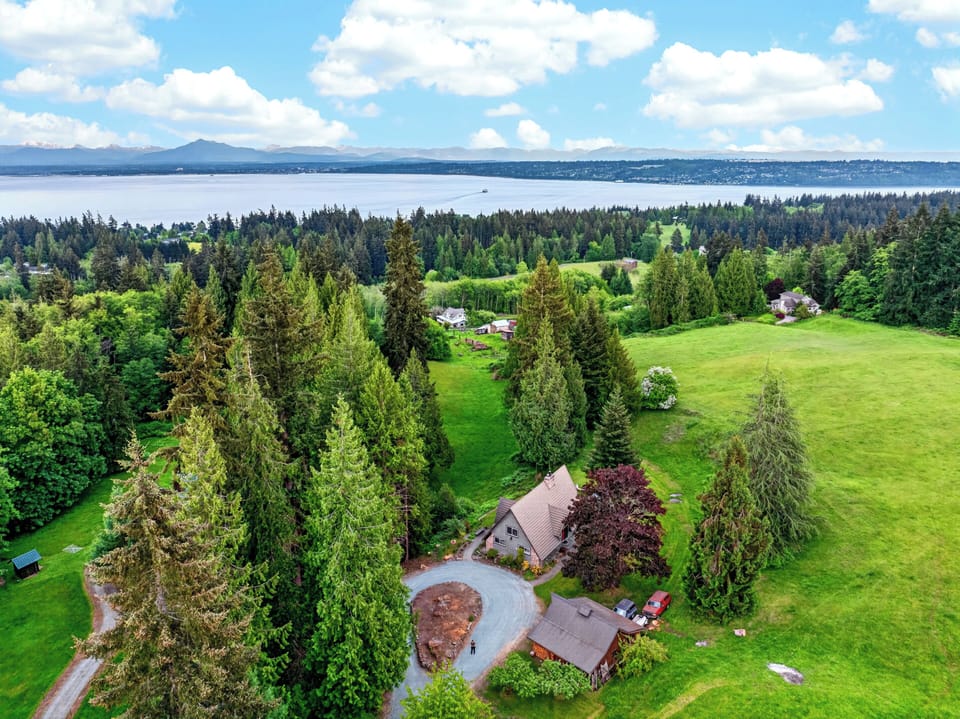 A private Whidbey Island retreat surrounded by evergreens, open lawns, and sweeping water views.