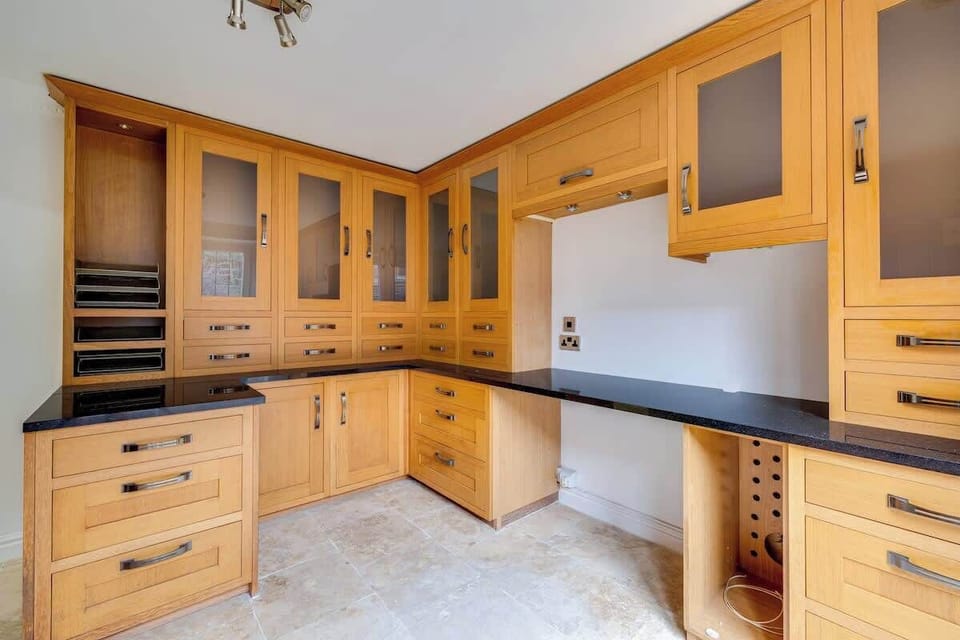 A dedicated workspace designed for productivity and comfort. This well-lit office features built-in cabinetry, ample storage, and a spacious work surface — perfect for remote work, studying, or handling business tasks in privacy.