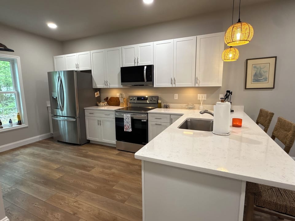 Kitchen features refrigerator, microwave, stove, and dishwasher.