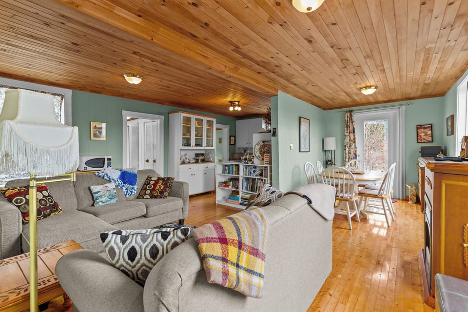 Open-concept living area with comfortable seating and rustic charm