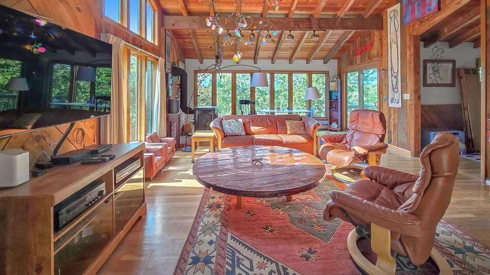 Living room has comfortable seating and a large flat screen TV