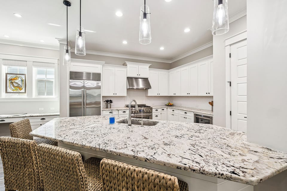 Your gourmet kitchen features stainless steel appliances and a spacious island perfect for meal prep or casual dining with friends and family.