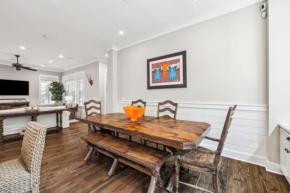 Gather around this rustic farmhouse table where your family can share meals and create memories together in this welcoming open-concept space that seamlessly flows into the living area.